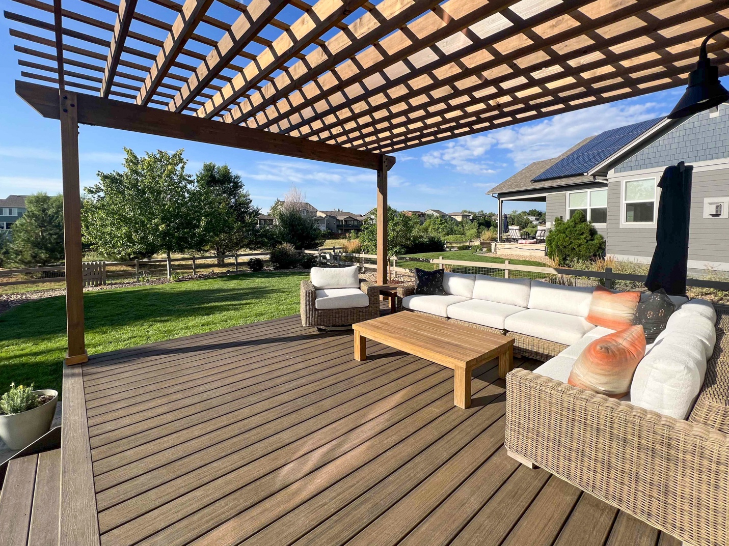 A patio with a wooden deck and a covered patio

Description automatically generated with medium confidence