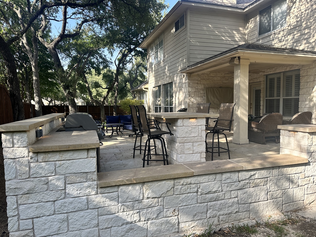 after photo of stone patio area with built in kitchen