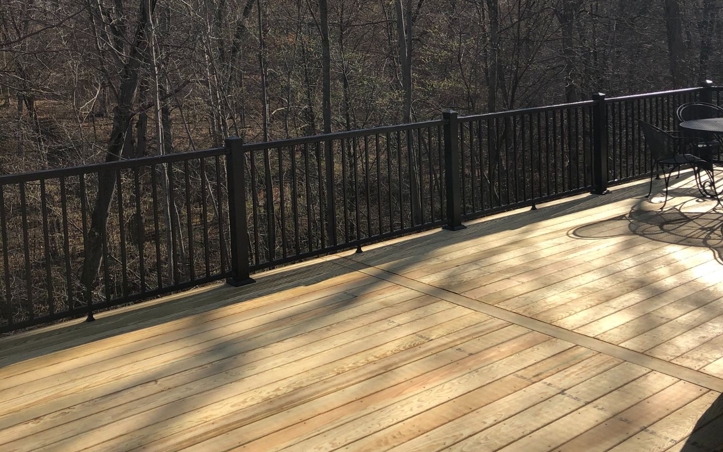 A deck with a black railing
AI-generated content may be incorrect.