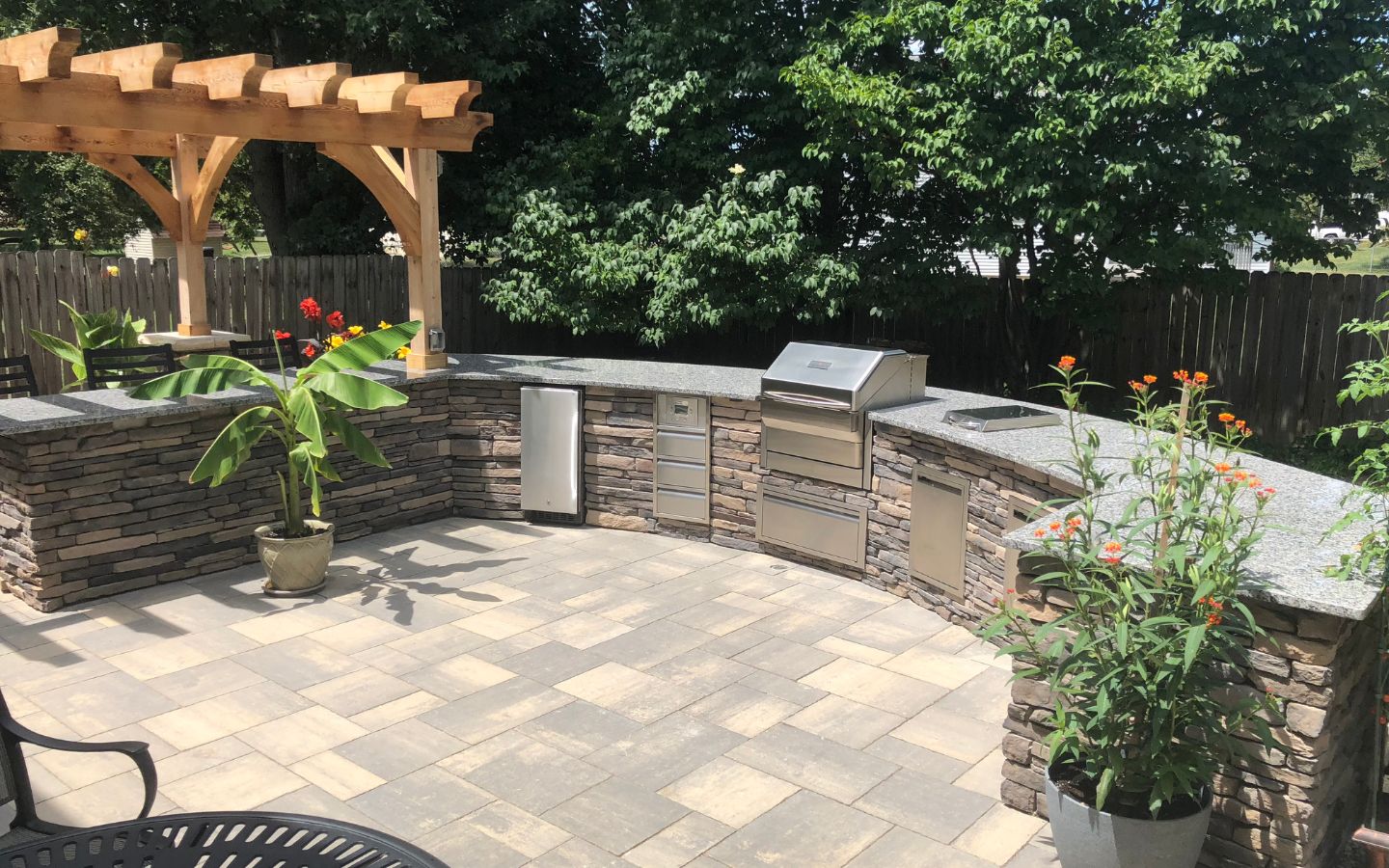 A patio with a grill and a pergola

AI-generated content may be incorrect.