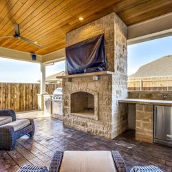 Forney Custom Covered Patio With Fireplace And Outdoor Kitchen.