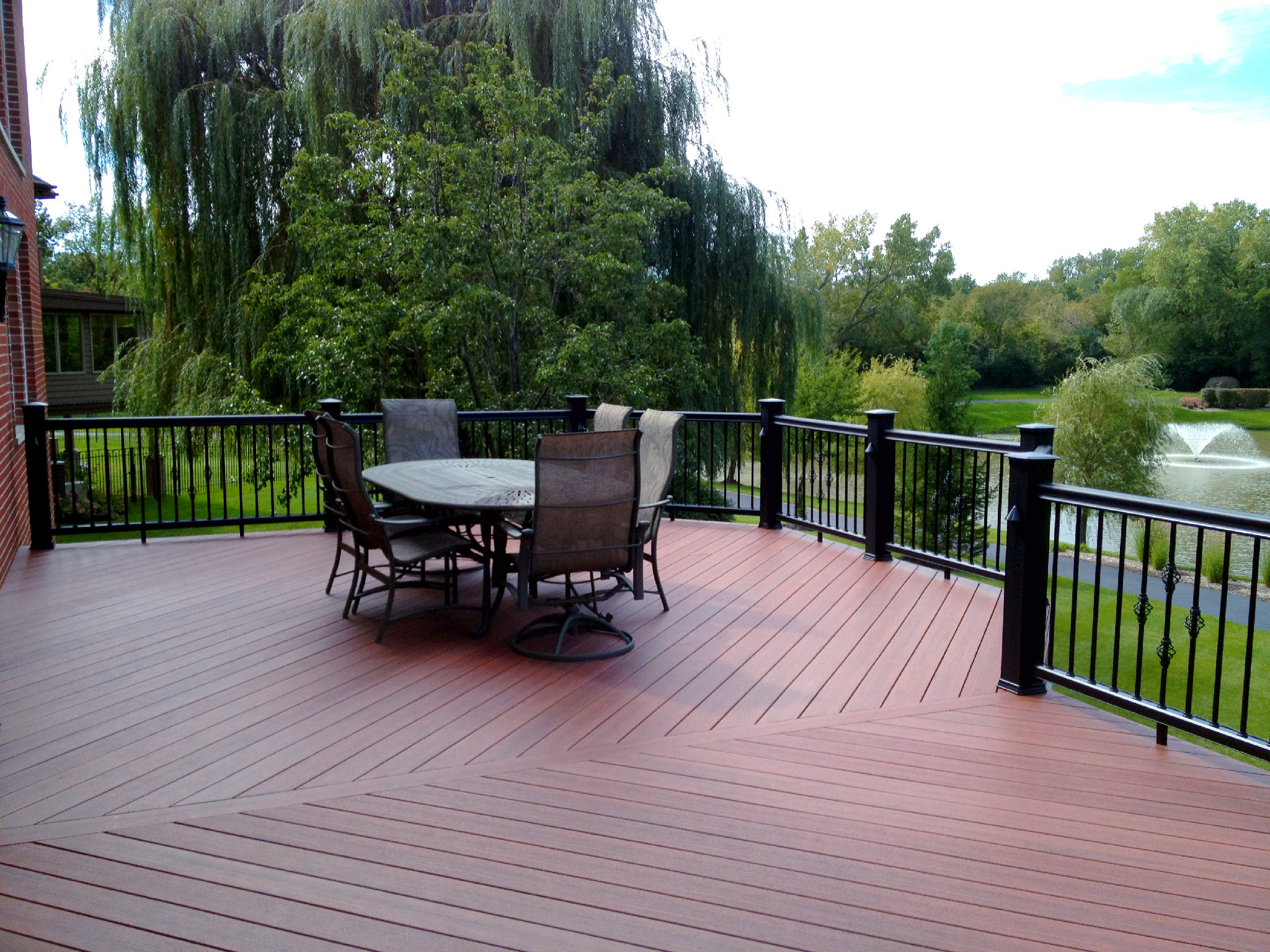 Composite deck overlooking a stunning pond built by local deck contractors Archadeck.