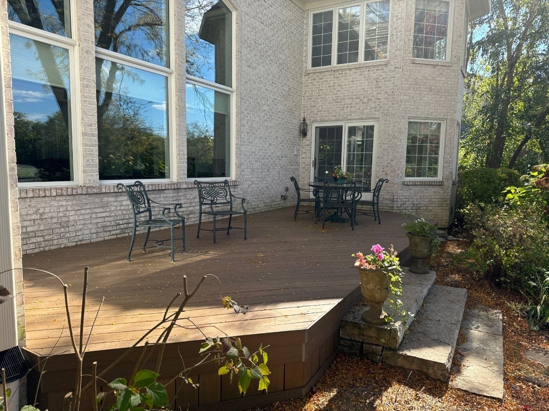 Custom brown platform Composite deck in Long Grove on a brick home.
