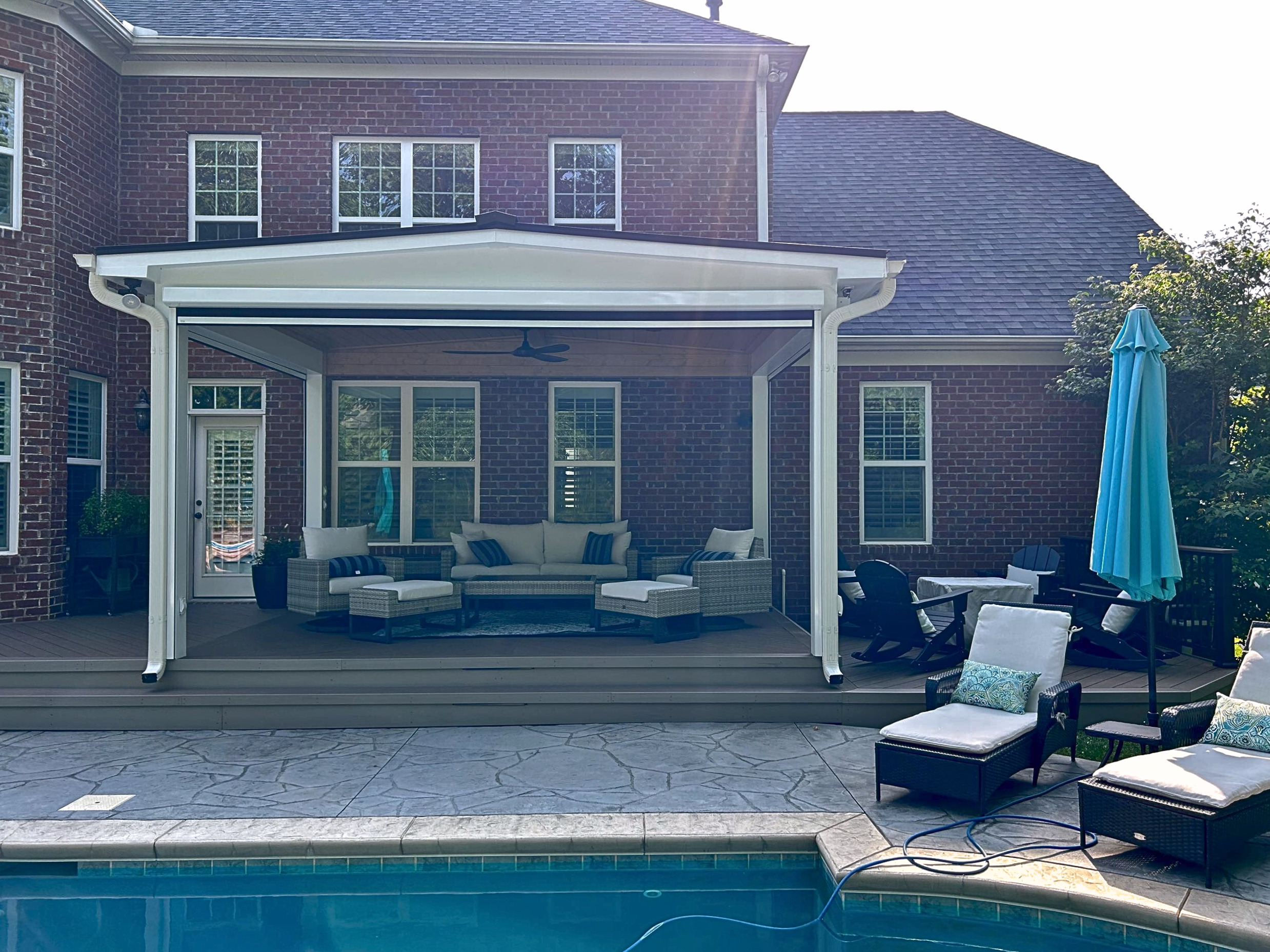 Back of home in Myers Park, NC featuring an open porch, composite deck, and paver patio.