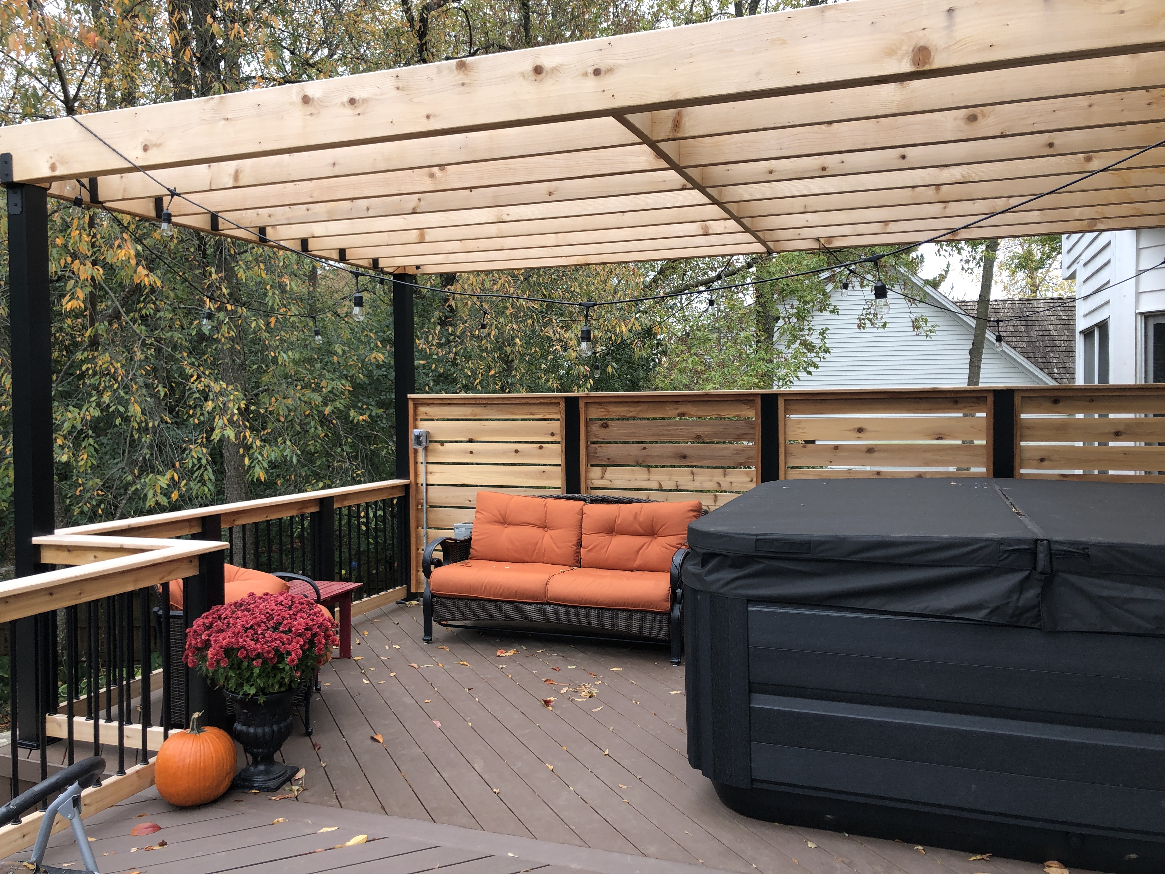 Custom cedar pergola over a TimberTech deck with a cedar privacy fence in Palatine, IL.