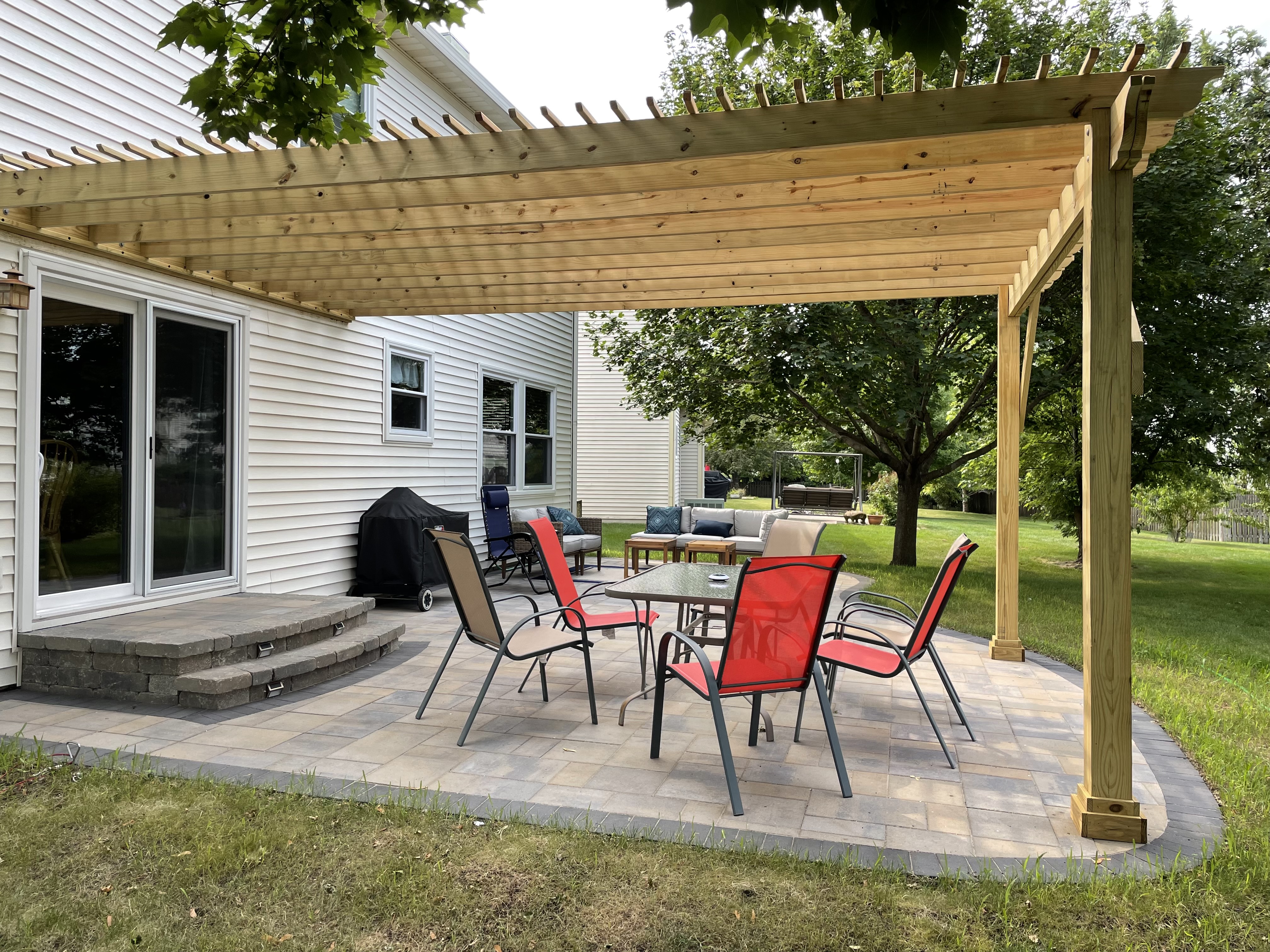 St. Charles custom pergola design featuring a wood pergola over a paver patio.