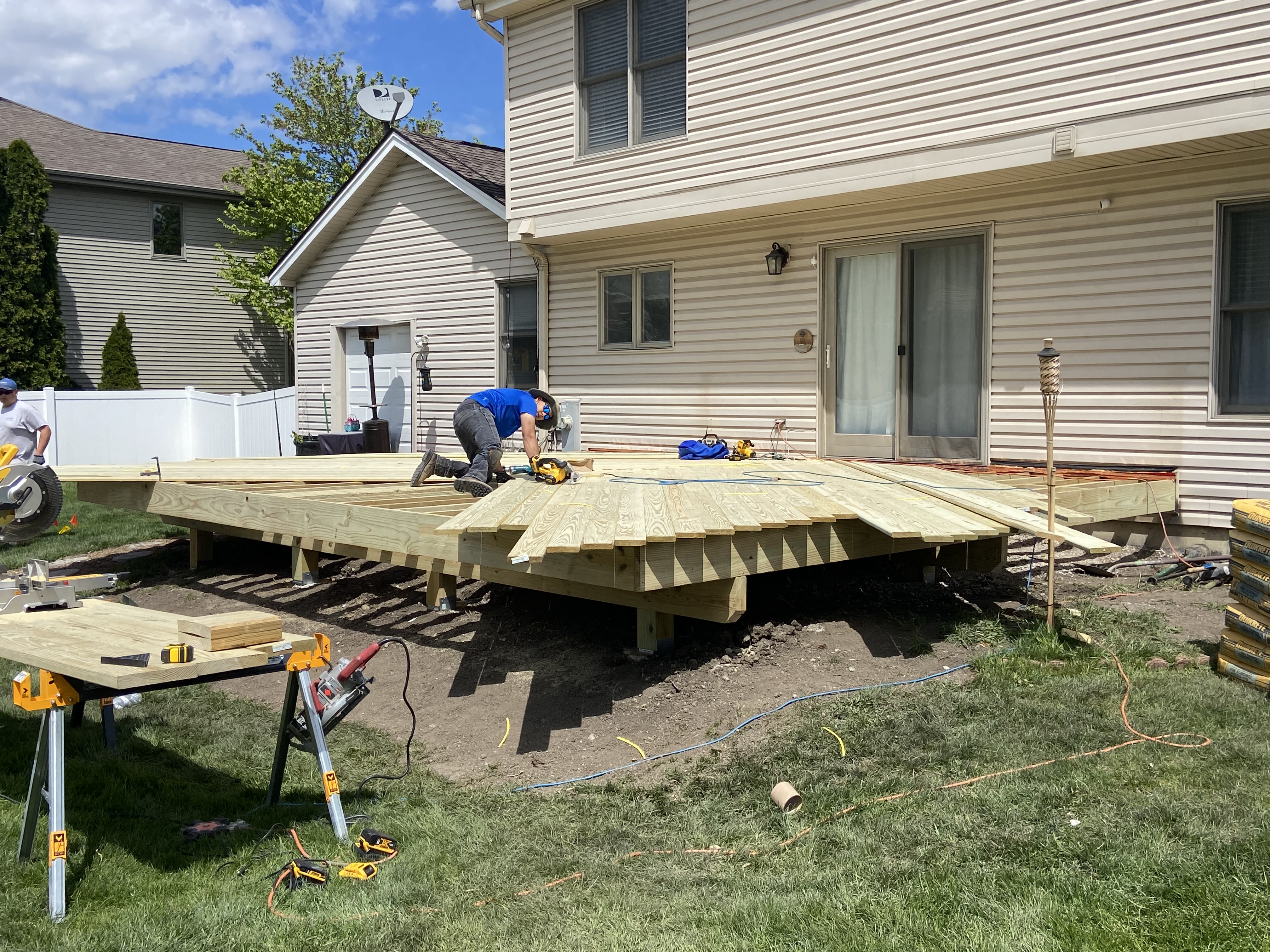 Archadeck deck installer installing wood decking.