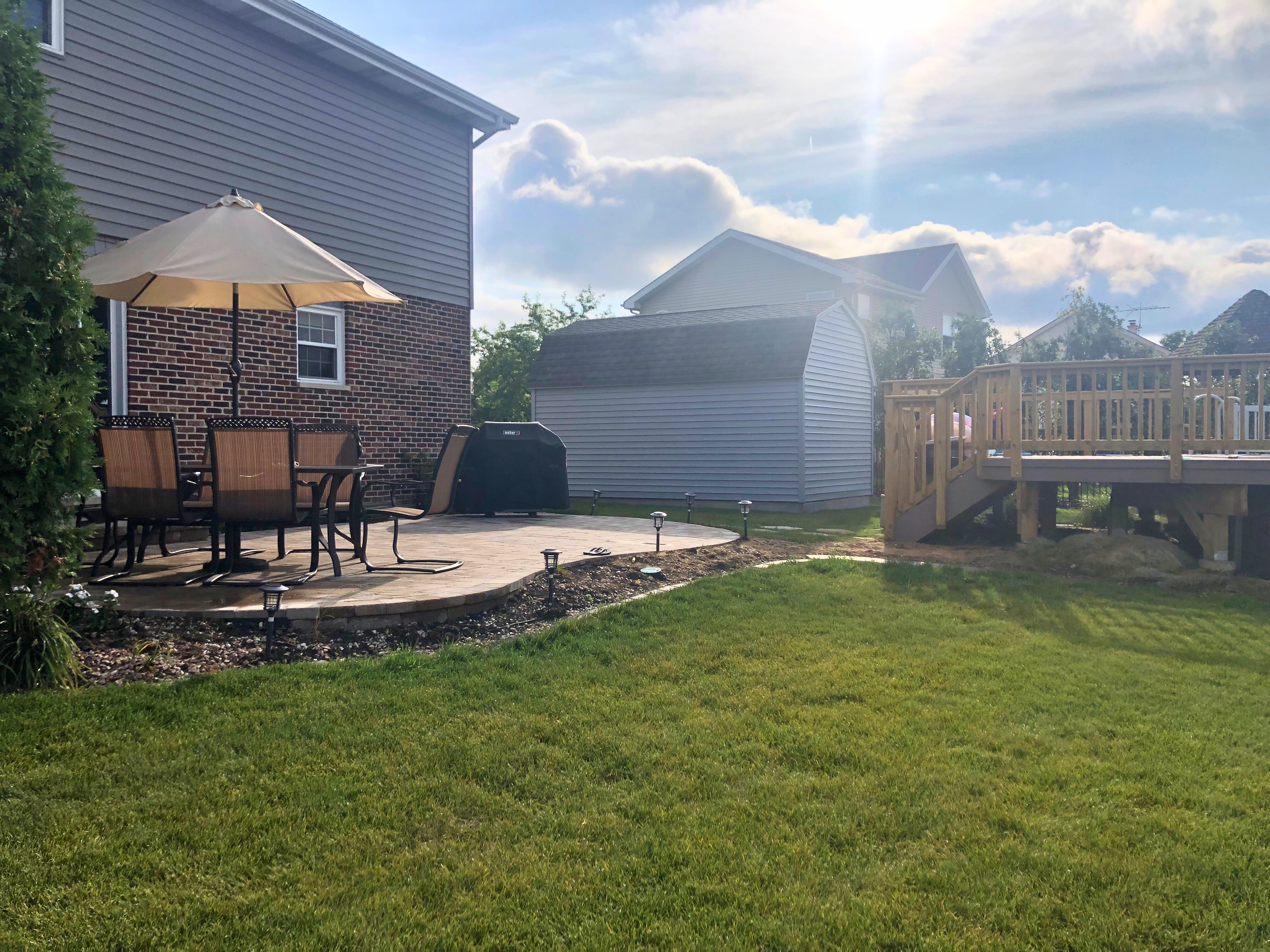 Frankfort, IL backyard featuring an Archadeck wood deck and paver patio.