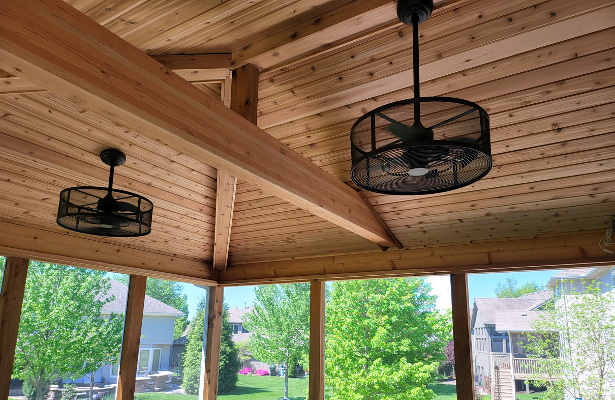 Hip roof screen porch interior with open beam aesthetic and cedar tongue and groove finish