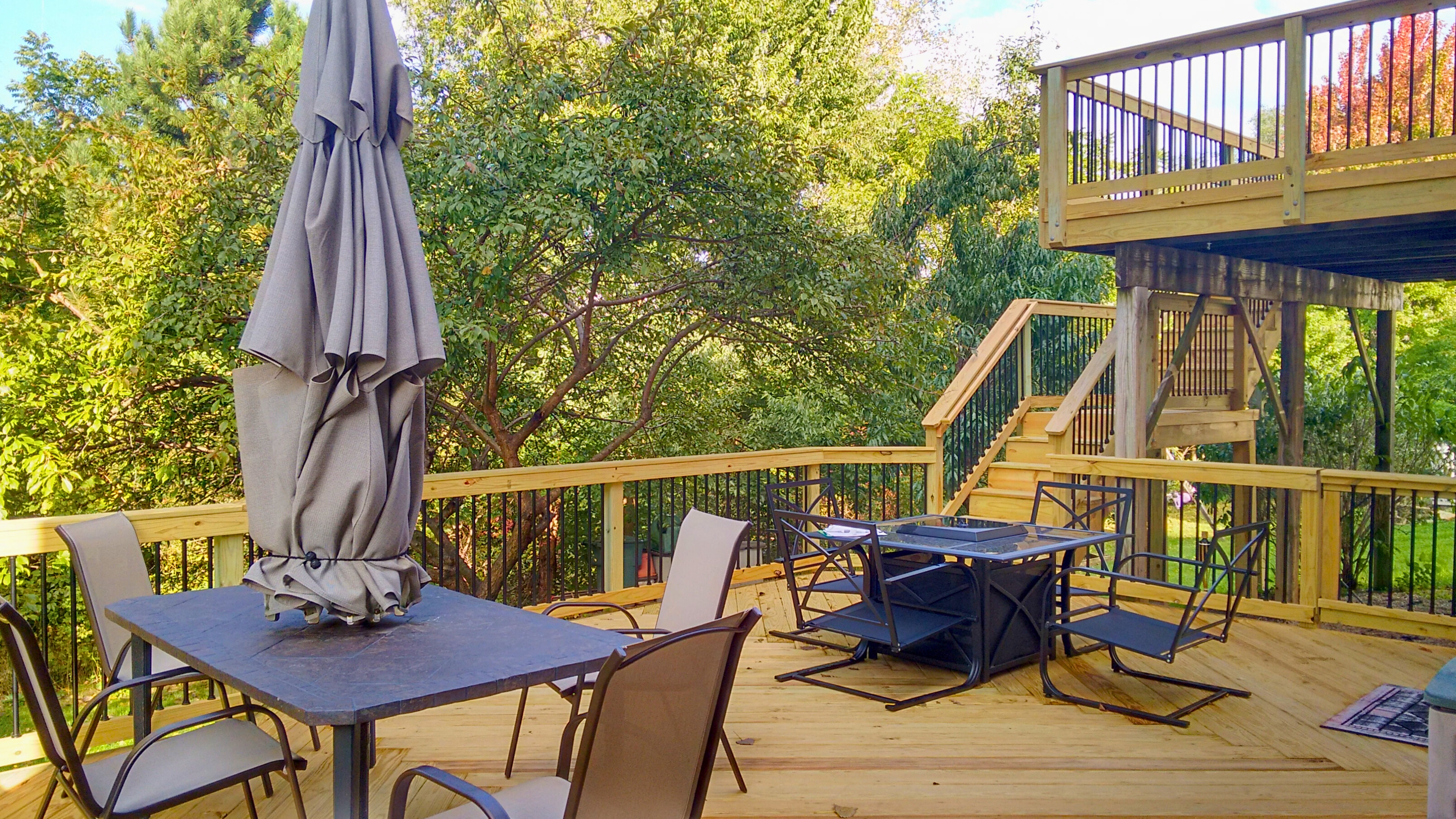 Multi-level wood deck overlooking green trees in Palatine, IL.