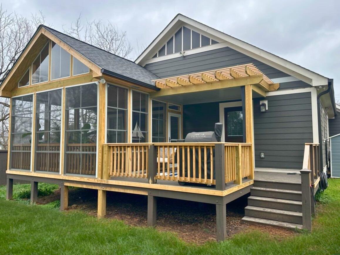 Custom grey composite deck, wood pergola, and and screened porch in Mecklenburg county.