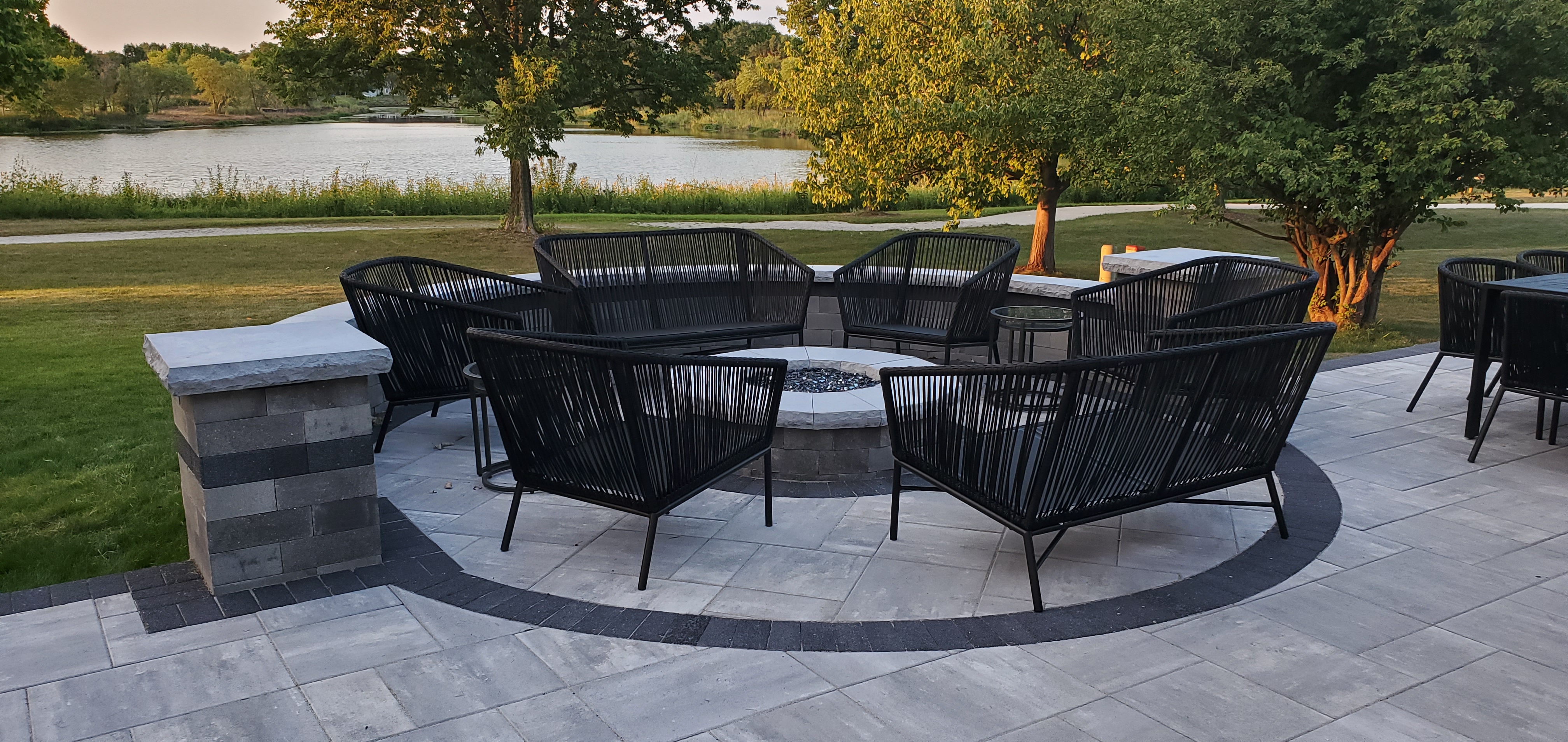Paver patio with inset circle, seat walls, and fire pit in Naperville, IL.
