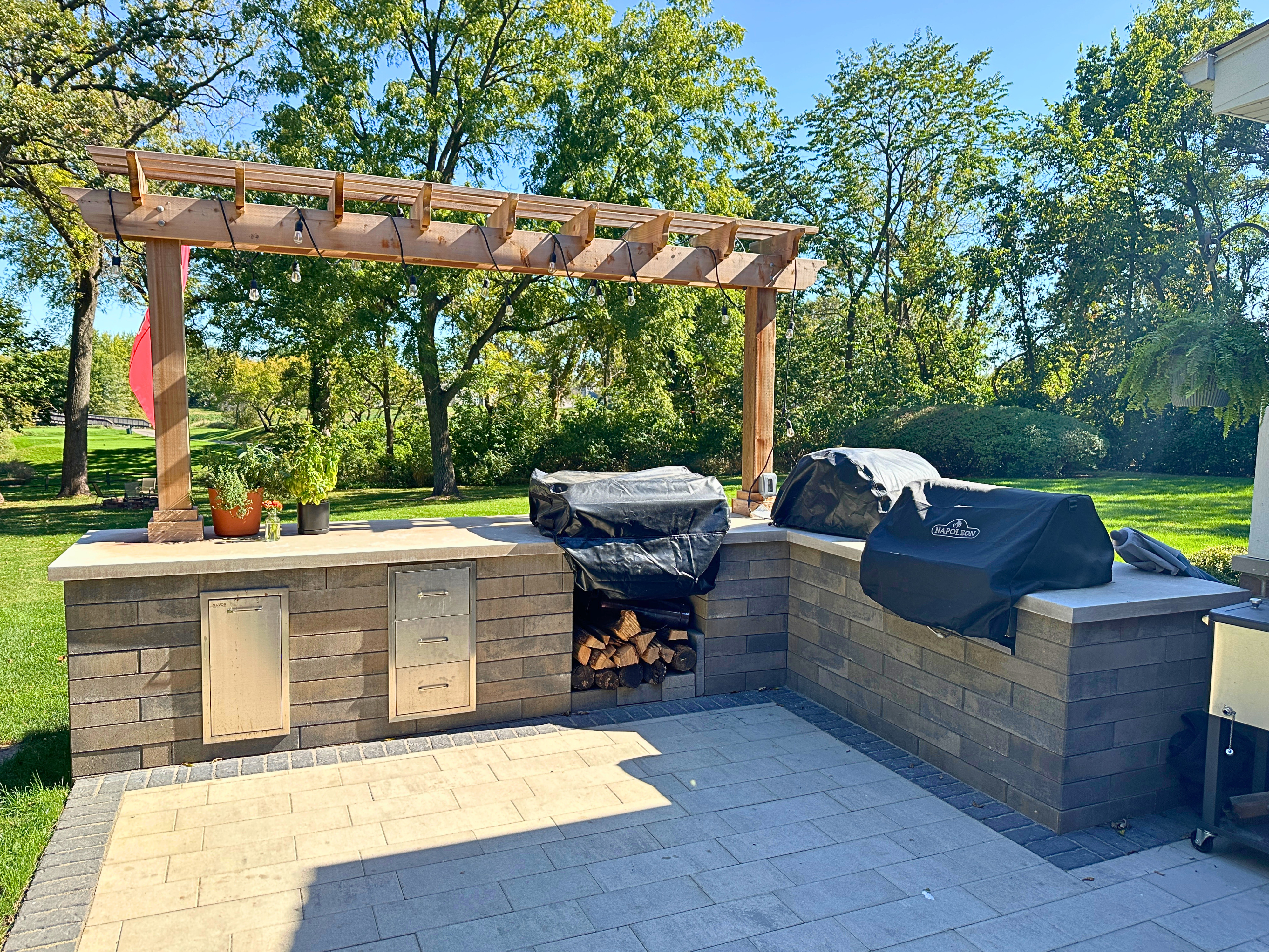 Stunning Naperville Outdoor Kitchen design with grill, pergola, and appliances.. 