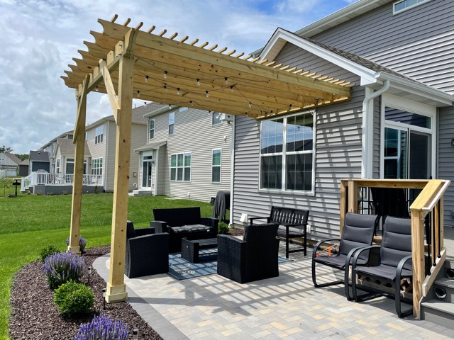 Attached pressure treated pine pergola over paver patio in Libertyville, IL.