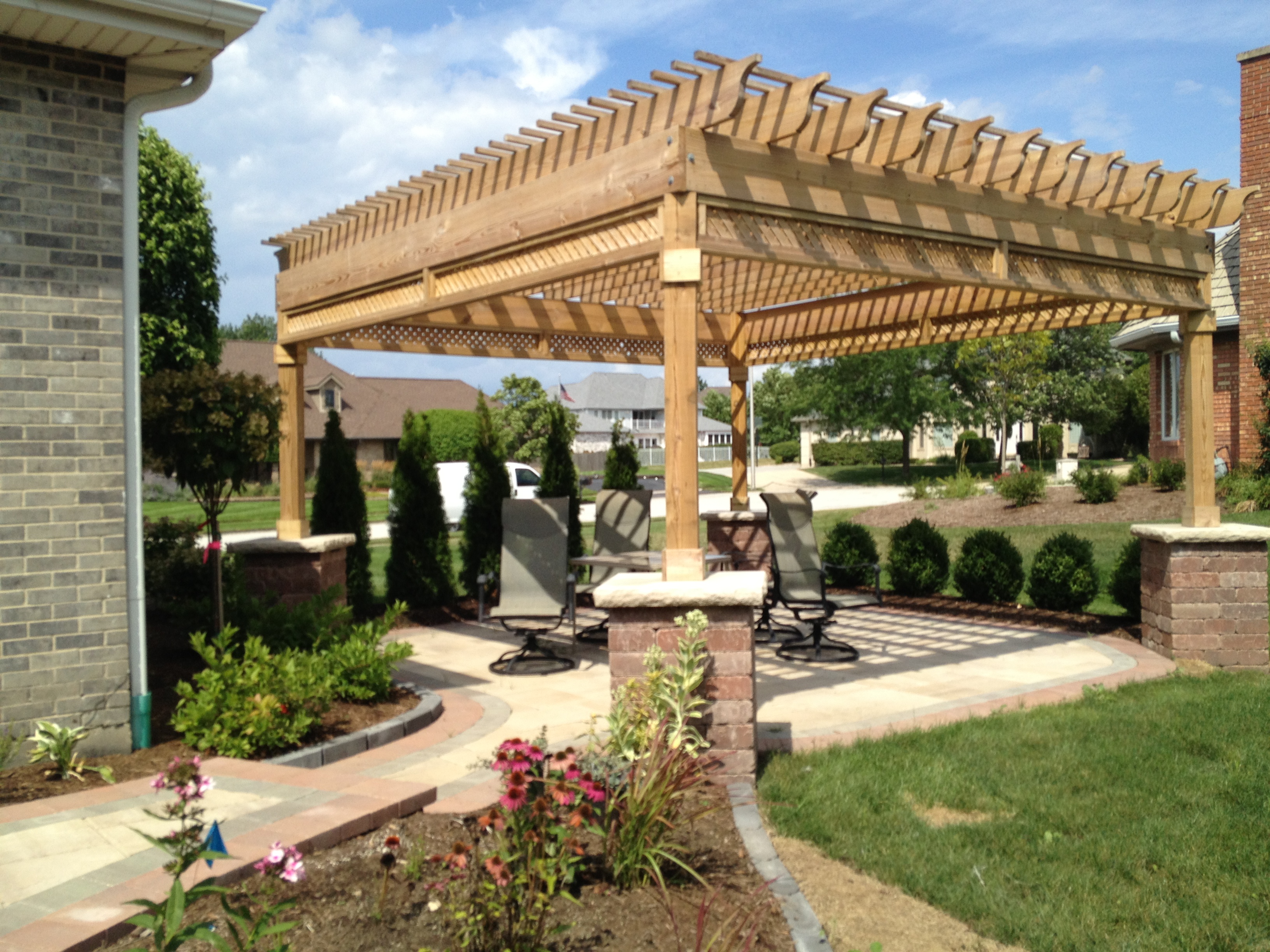 Custom paver patio and pergola with pillars in Orland Park, IL.