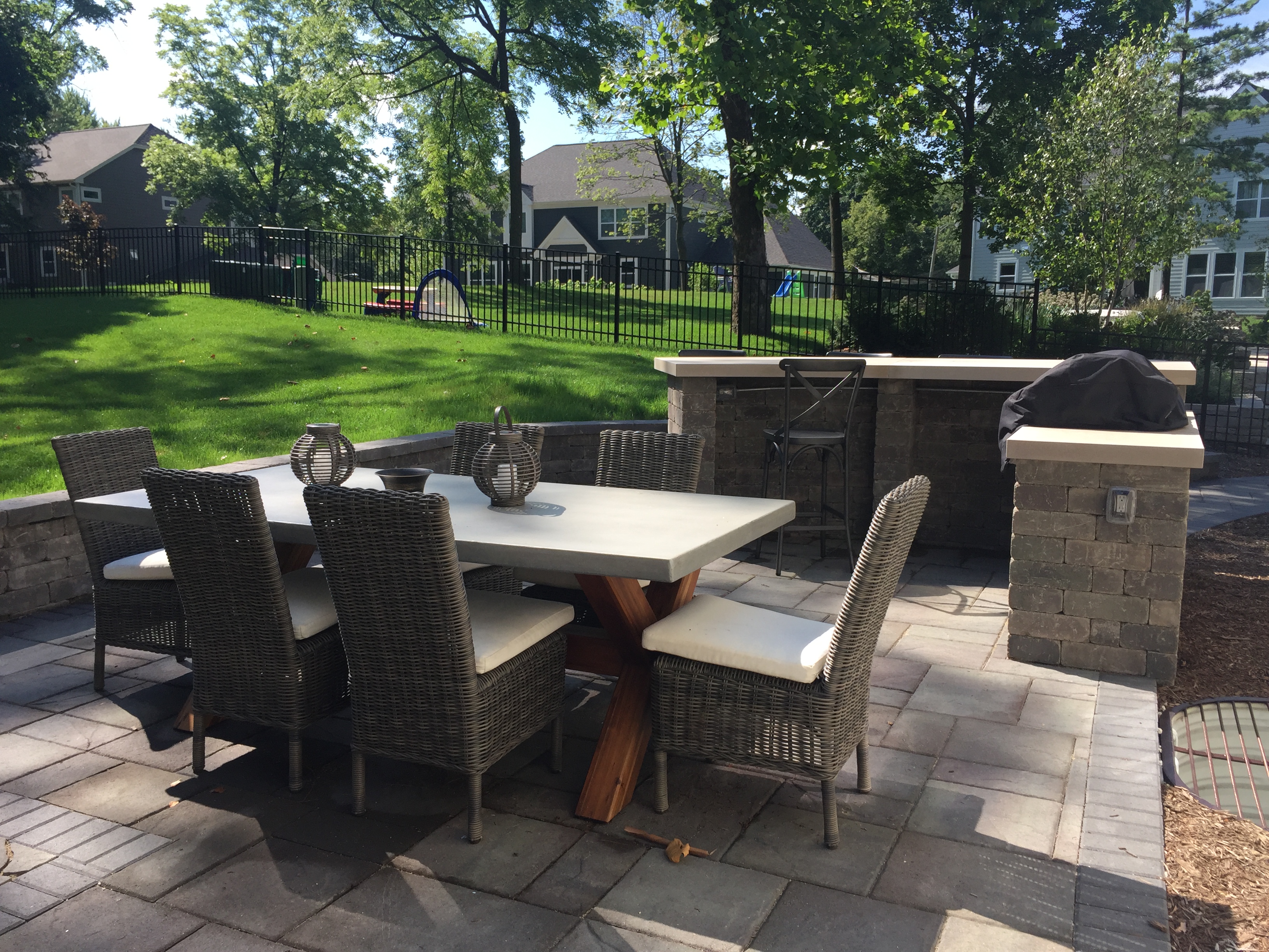 Paver patio and outdoor kitchen overlooking backyard in Glen Ellyn.