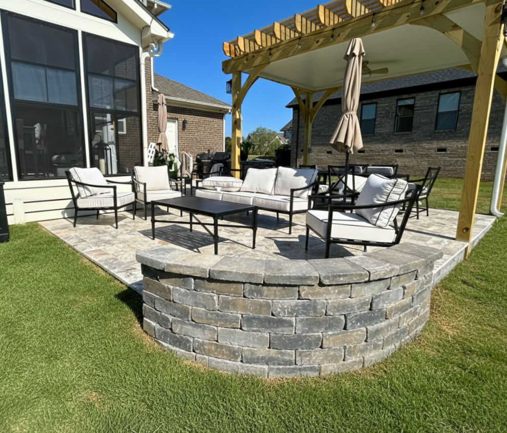 Custom paver patio with seatwall, screened porch, and pergola in Charlotte, NC.