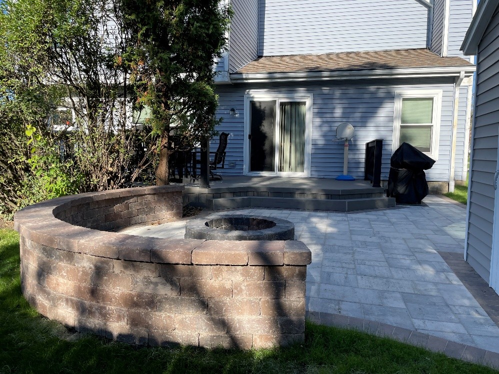 Custom paver patio, fire pit, and seat wall in Aurora, IL.
