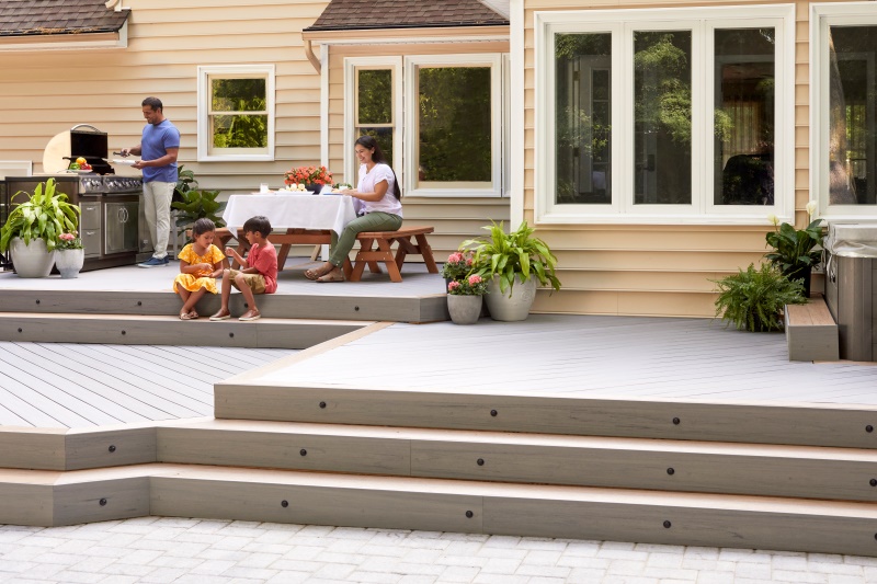 Composite Deck with Stairs and Family Barbecuing
