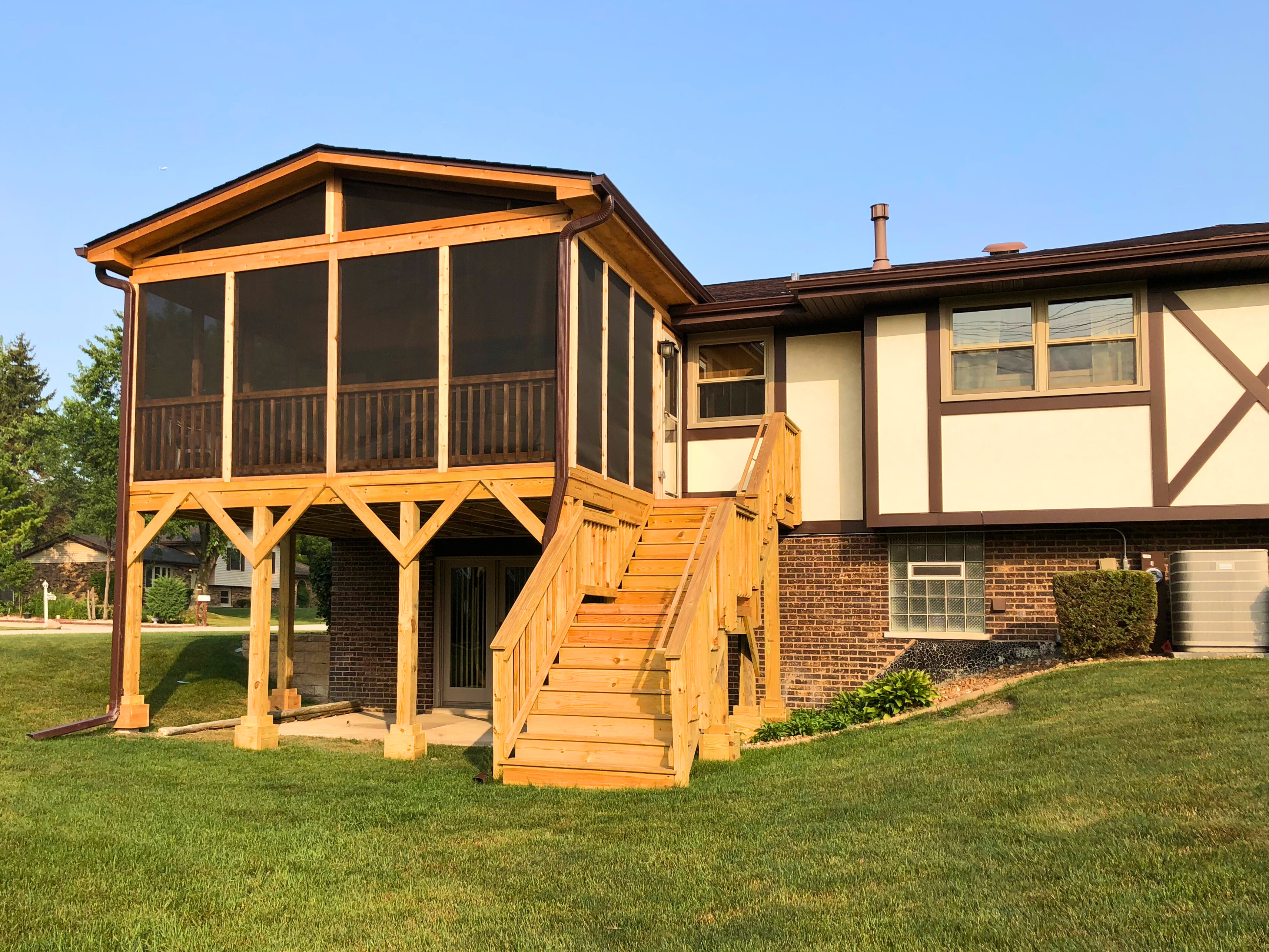 Gorgeous screened porch and wood deck on the back of an Orland Park home.