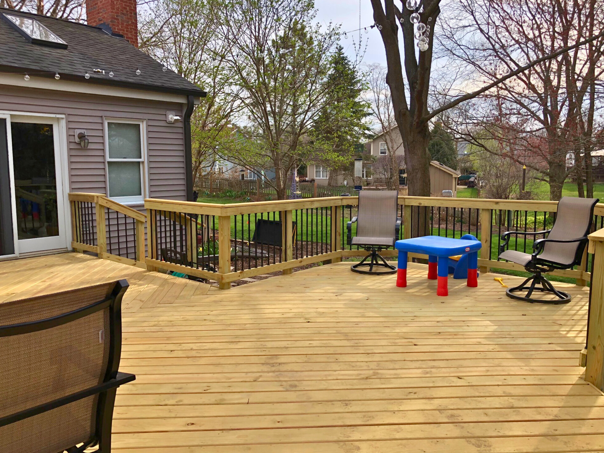 Custom wood deck with black aluminum pickets in Lake Zurich, IL..