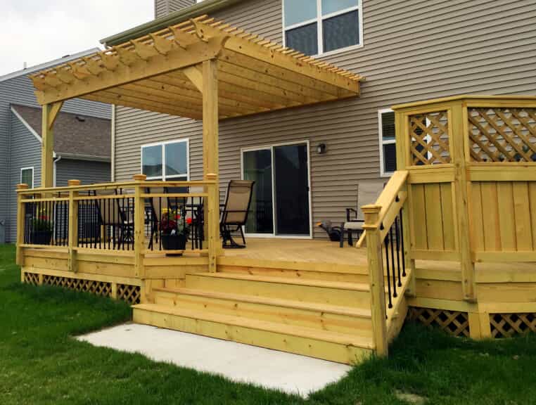 Custom wood deck with lattice privacy fence and pergola in Naperville, IL.