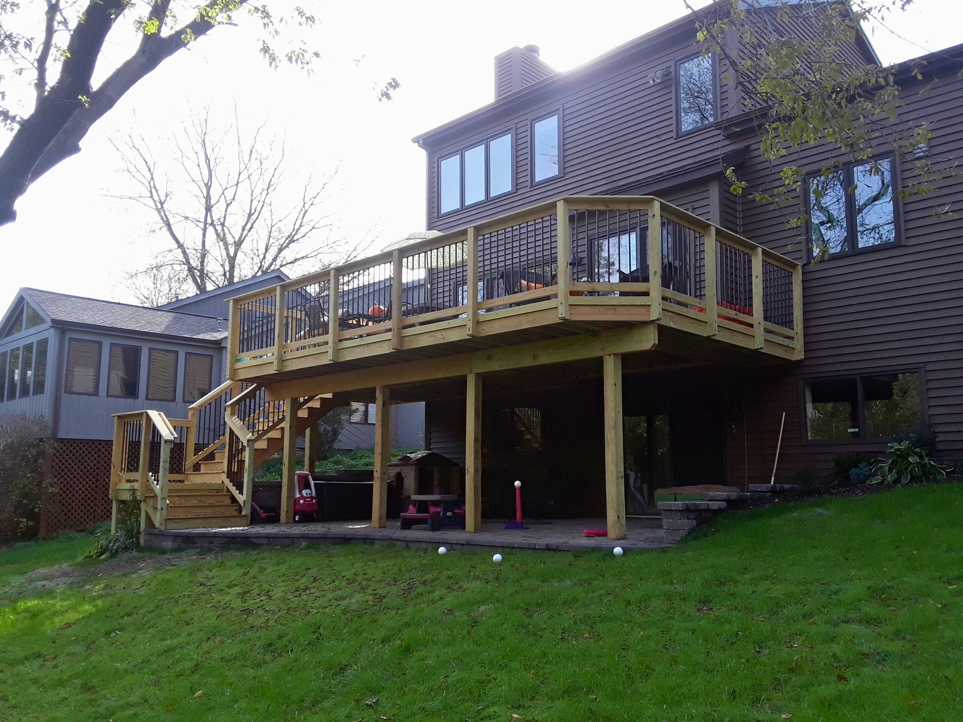 A custom-built wooden deck with a wide staircase, constructed by an experienced deck builder in Woodridge.