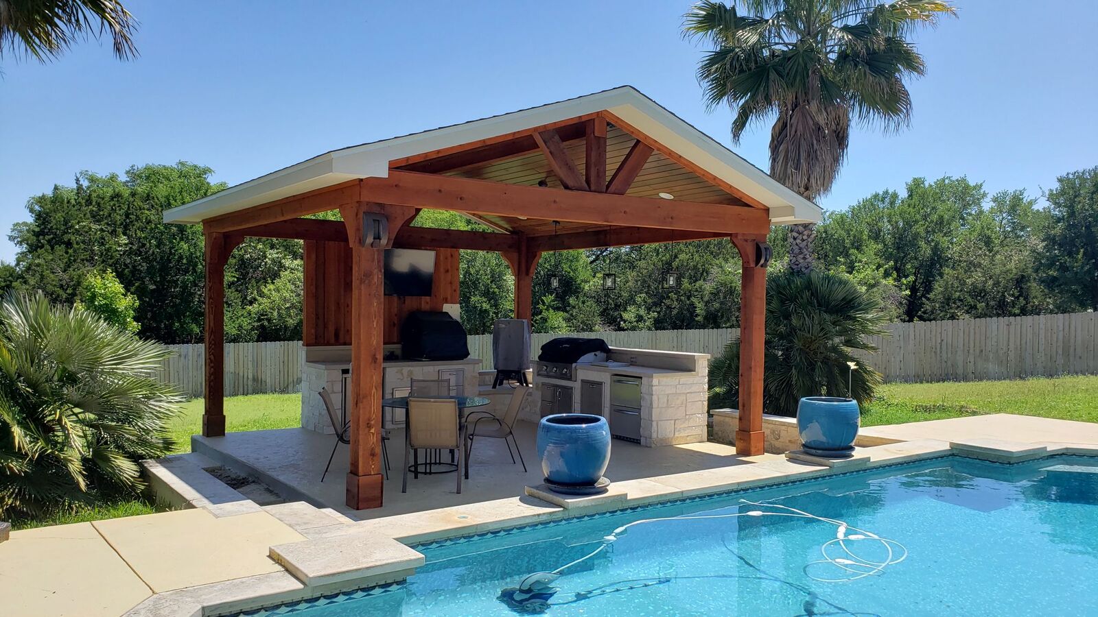 covered barbecue area by a pool