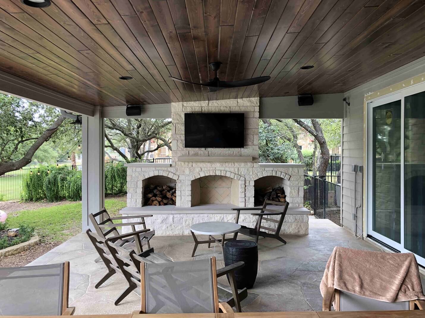 Outdoor fireplace attached to covered patio