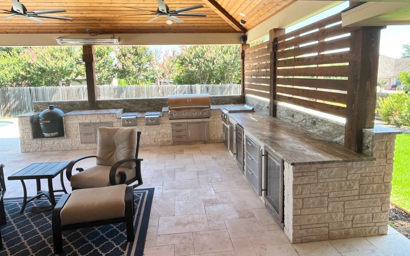 A patio with a grill and a table
Description automatically generated