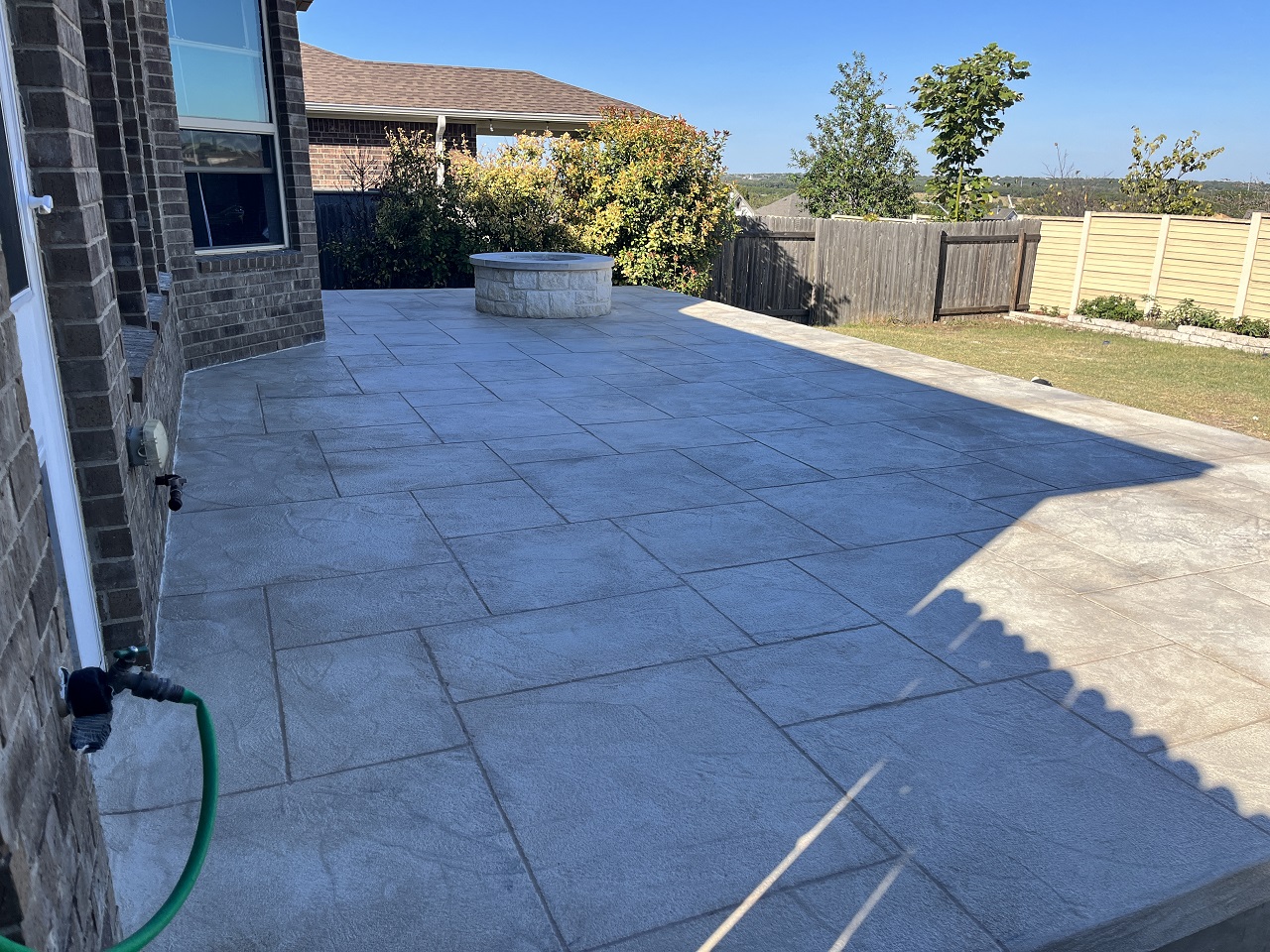 custom patio with wood burning fire pit leander tx