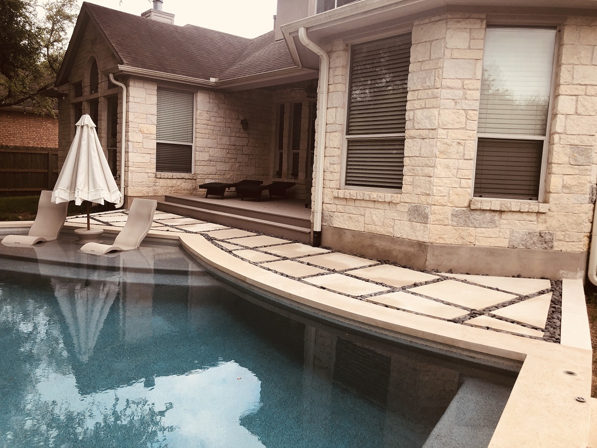 custom poolside outdoor living space