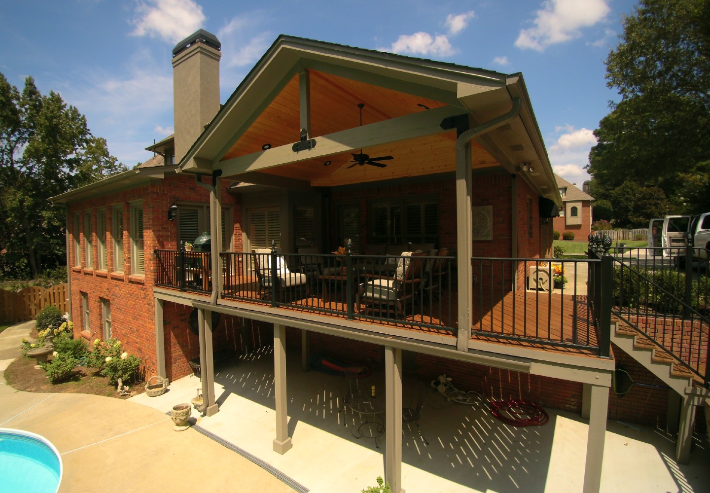 A house with a deck and a patio
Description automatically generated