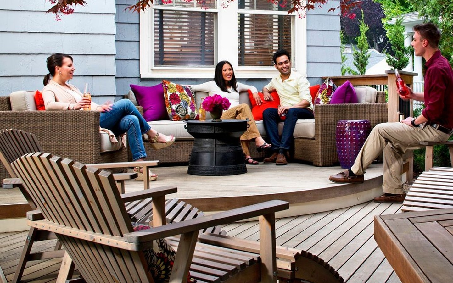 A group of people sitting on a deck
Description automatically generated