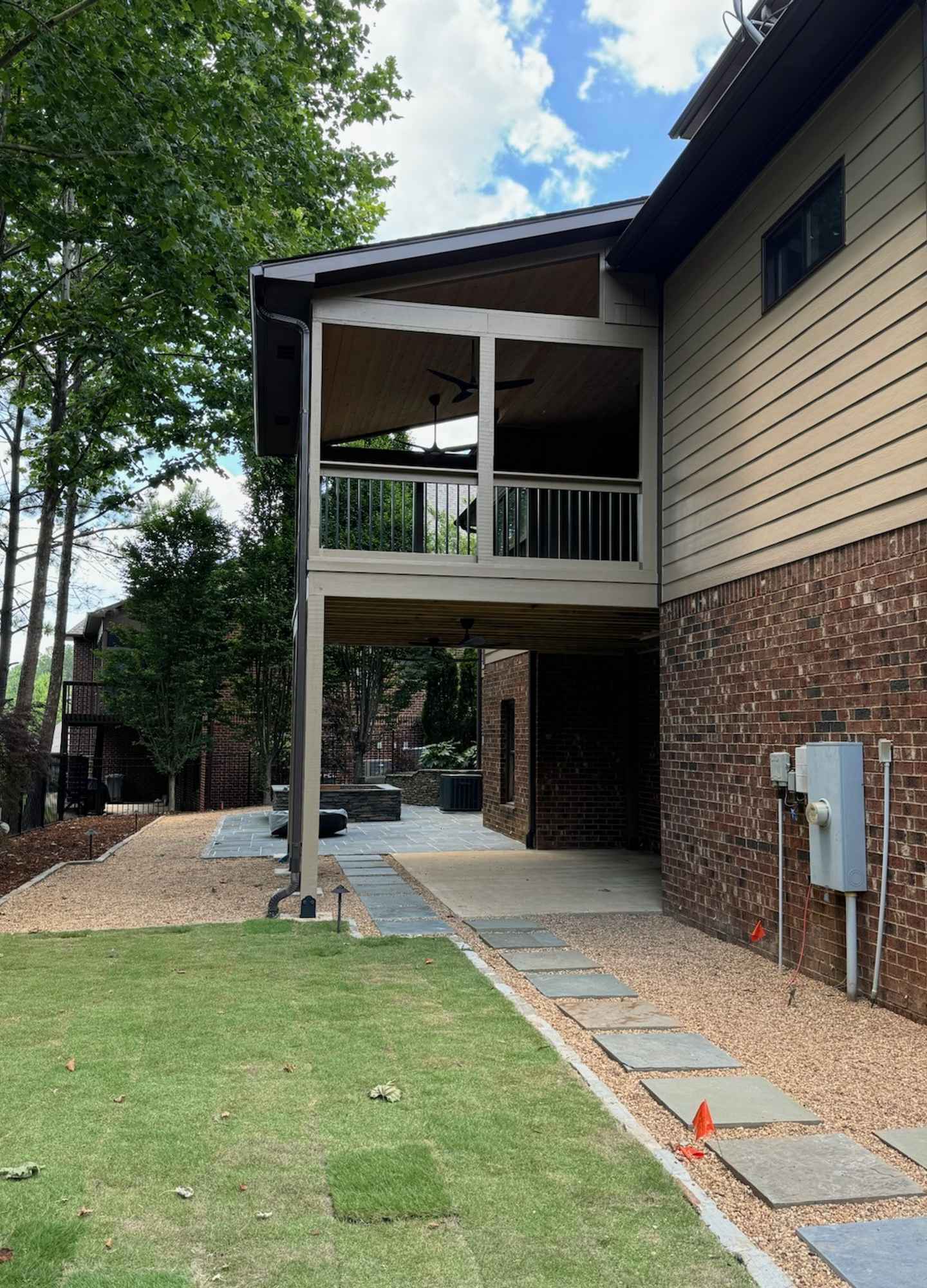 A house with a patio and a lawn

Description automatically generated