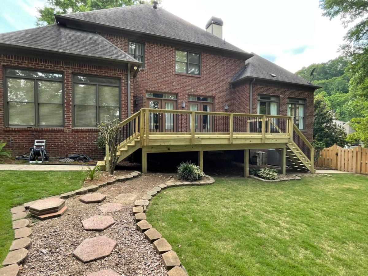 Outdoor wooden deck in backyard with walkway