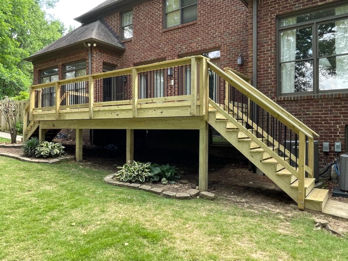 Outdoor wooden deck in backyard with walkway