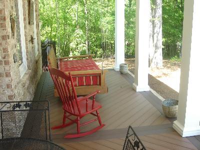rocking chair and swing chair on front porch deck