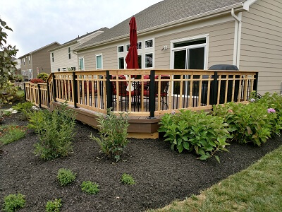 deck with railings and plants on the side