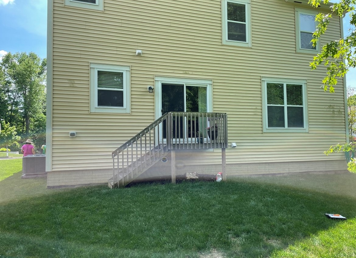 Yellow house with tiny stair porch