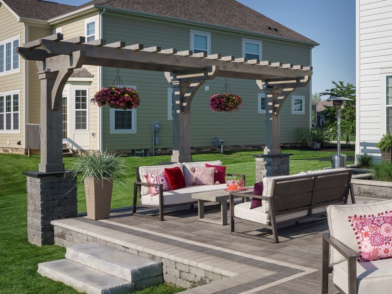 patio in a backyard behind a large house