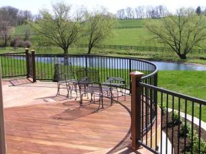 IPE deck with curve makes a statement and creates a great area, out of traffic pattern, to enjoy the great view. Powder coated black rail minimizes the intrusion on the view.