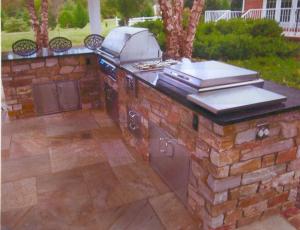 This multi-functional outdoor kitchen features "eat in" style bar seating