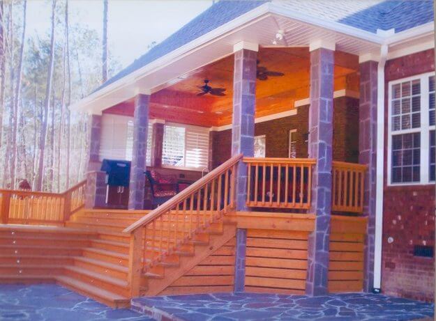 This open porch and patio combination mixes the rustic tones of wood and stone together and soothes all the senses through texture and tone.