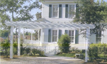 This pergola makes a statement as the entrance to this charming South Carolina low-country style home.