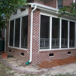 This vinyl fourtrack aluminum three season room with brick exterior blends seamlessly with home in Columbia. SC