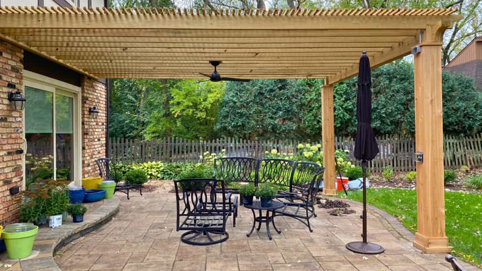 Stunning attached pergola with large cedar posts over a paver patio in Hawthorne woods, IL.