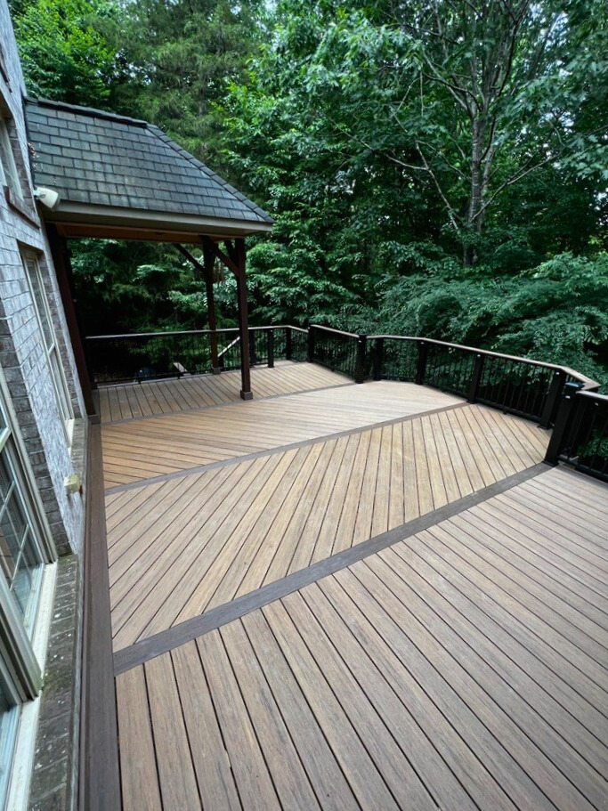 Custom composite deck with herringbone pattern overlooking trees in Davidson, NC.