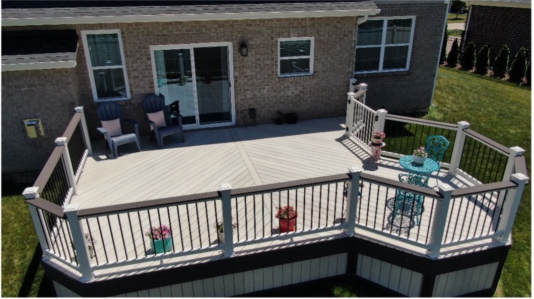 Gorgeous light-wash composite deck with herringbone pattern and brown rail cap in Naperville, IL.