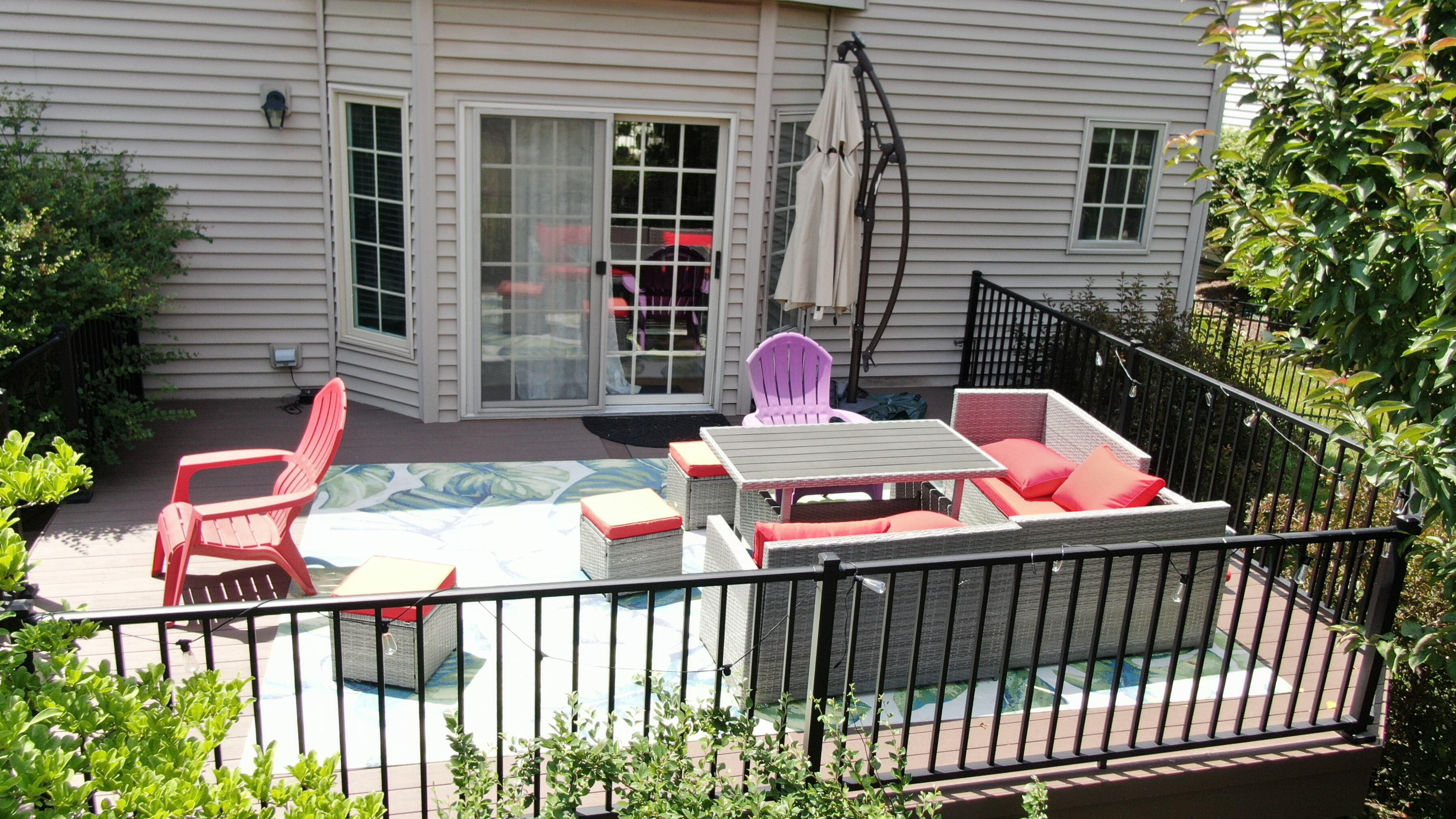 Custom composite deck with lounge furniture and aluminum rails in Naperville, IL.